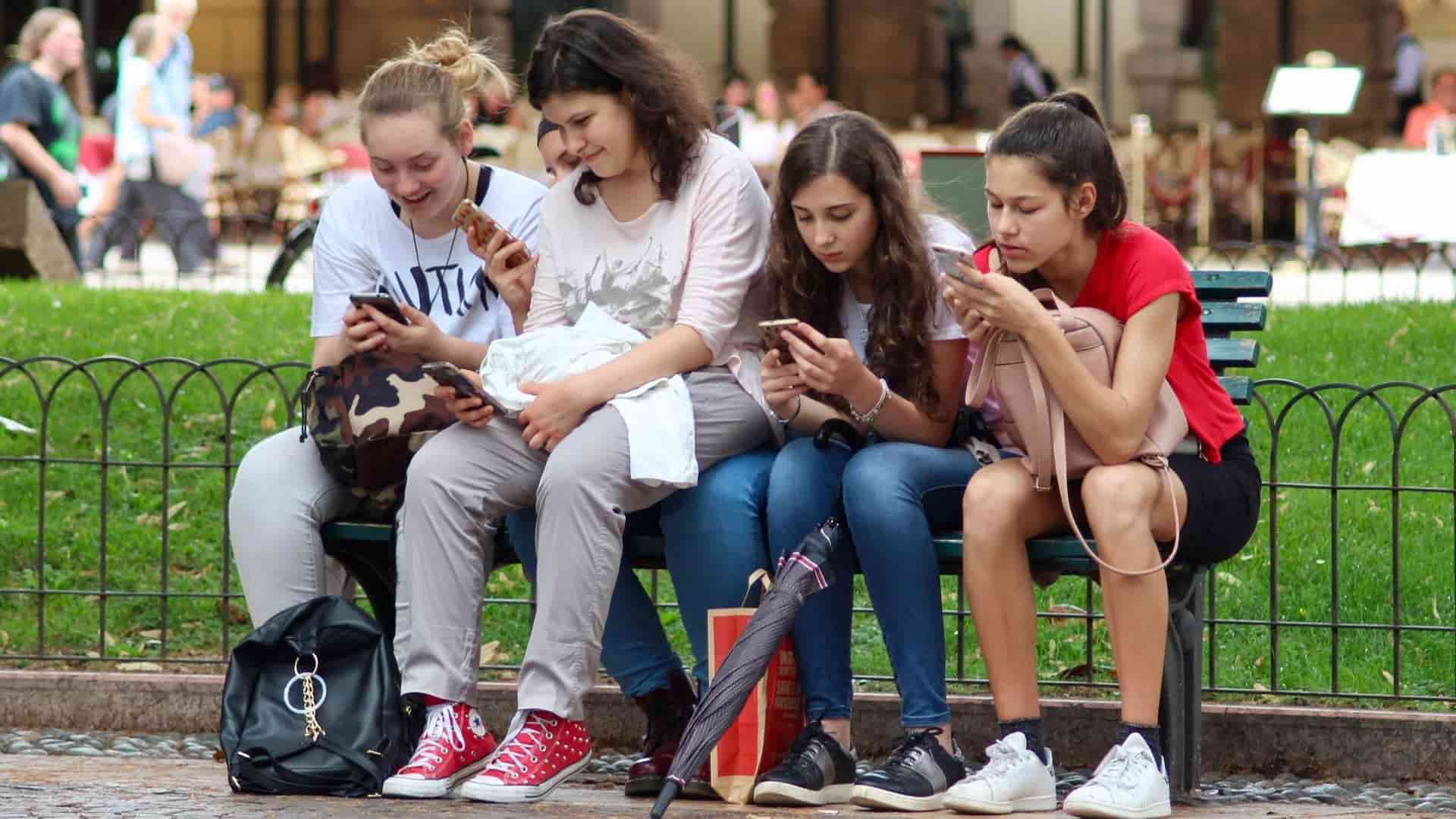 girls cell phones sitting